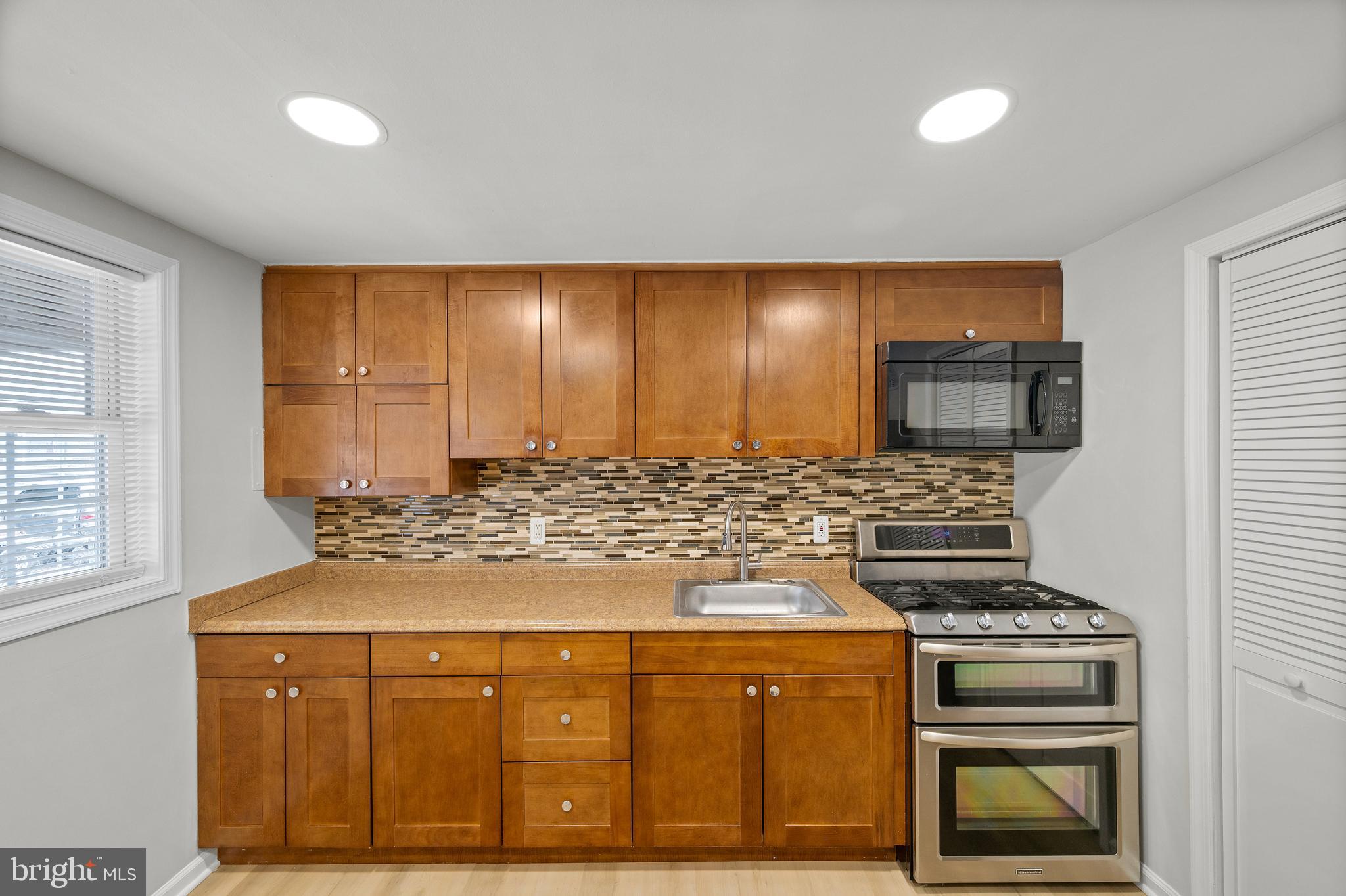 817 5th Baltimore, MD 21227 - Photo 4 of 29 a kitchen with stainless steel appliances granite countertop a stove a sink and a microwave