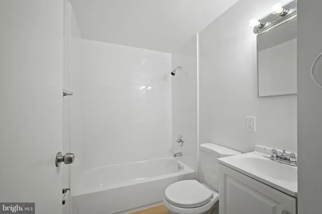 a white toilet sitting next to a bath tub