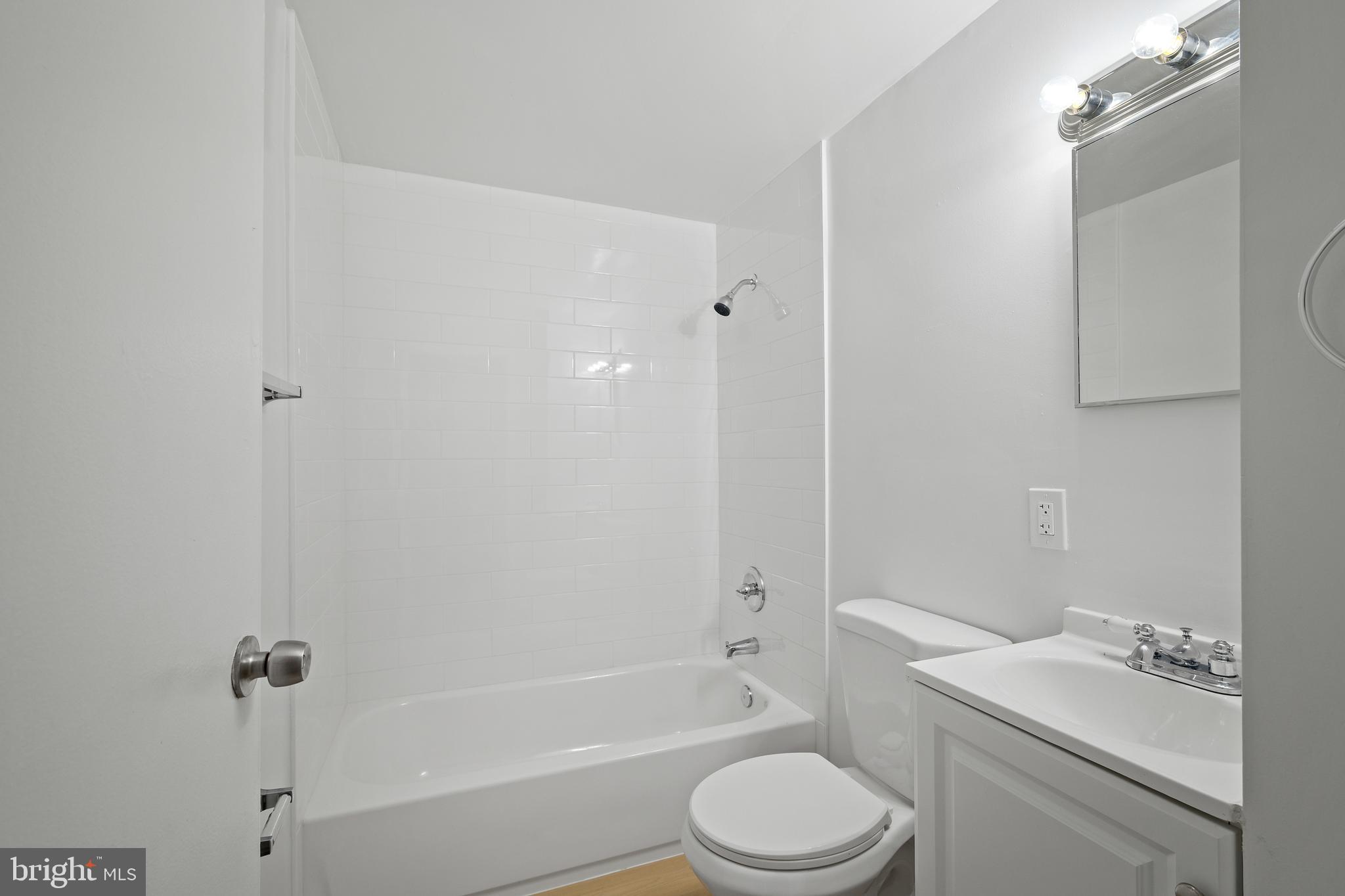 817 5th Baltimore, MD 21227 - Photo 6 of 29 a white toilet sitting next to a bath tub