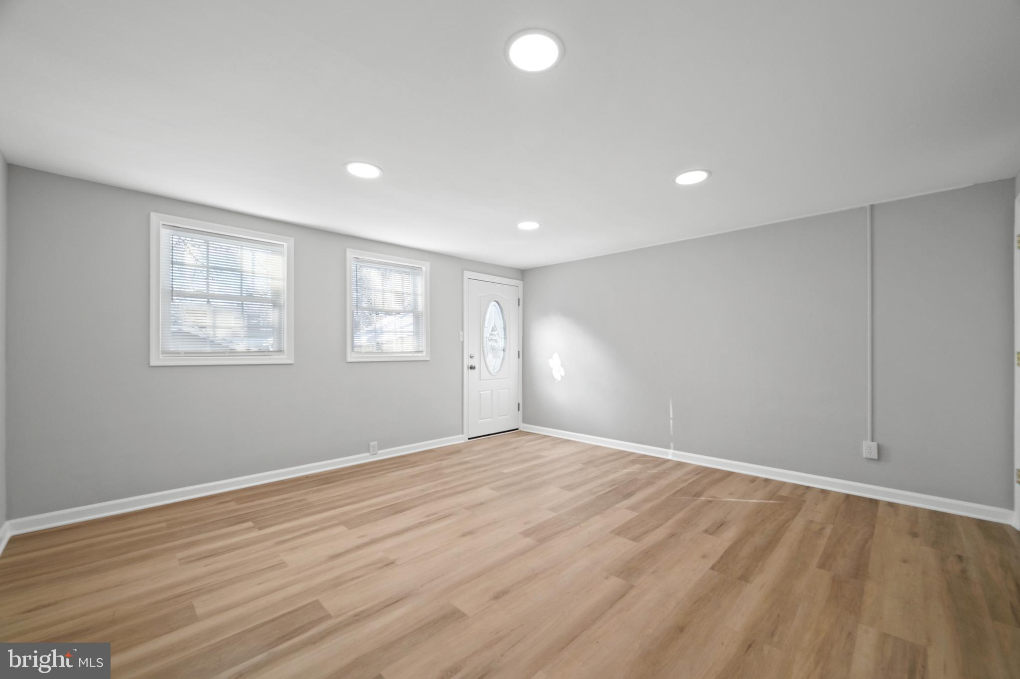 817 5th Baltimore, MD 21227 - Photo 10 of 29 a view of an empty room with wooden floor and a window