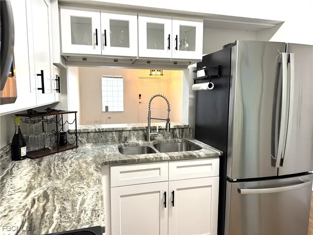 a kitchen with a refrigerator and a sink