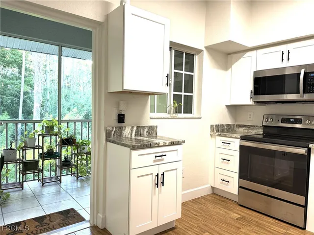 a kitchen with a stove a sink and a microwave