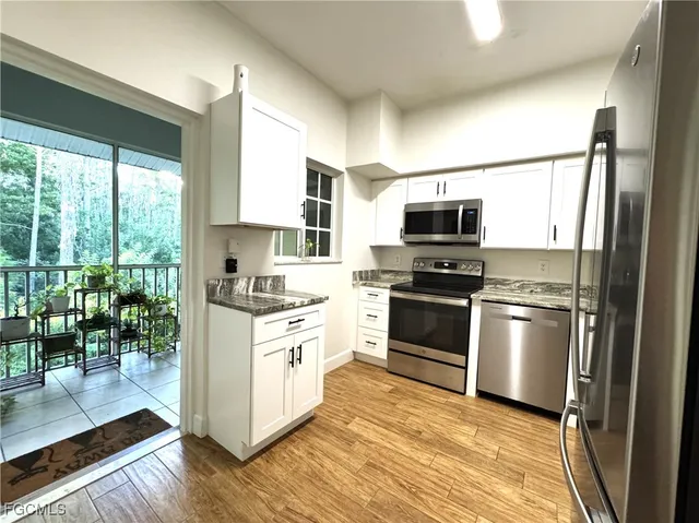 a kitchen with a stove a sink and a microwave