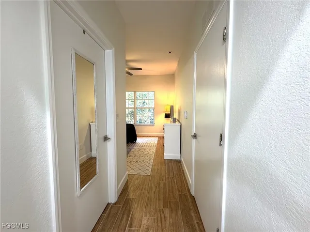 a view of a hallway with wooden floor
