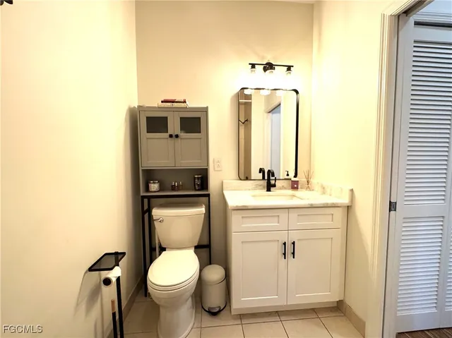 a bathroom with a toilet a sink and mirror