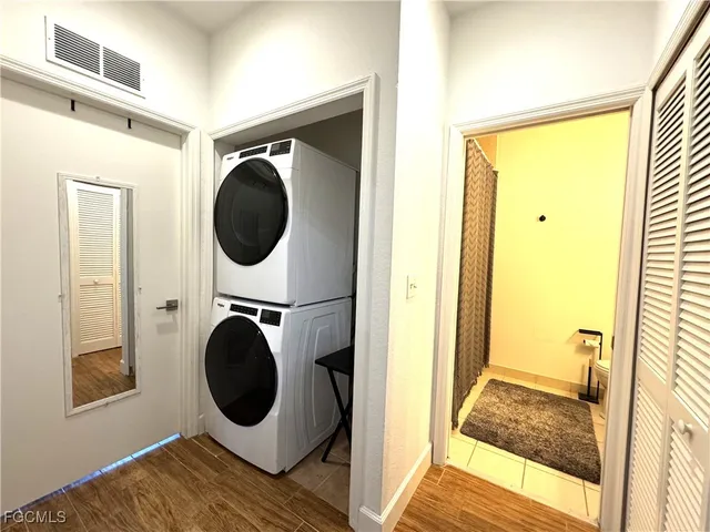 a view of a bedroom with washer and dryer