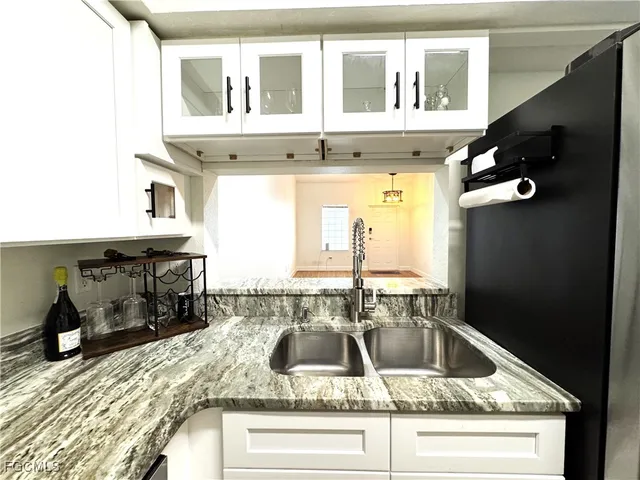 a kitchen with a sink and a refrigerator