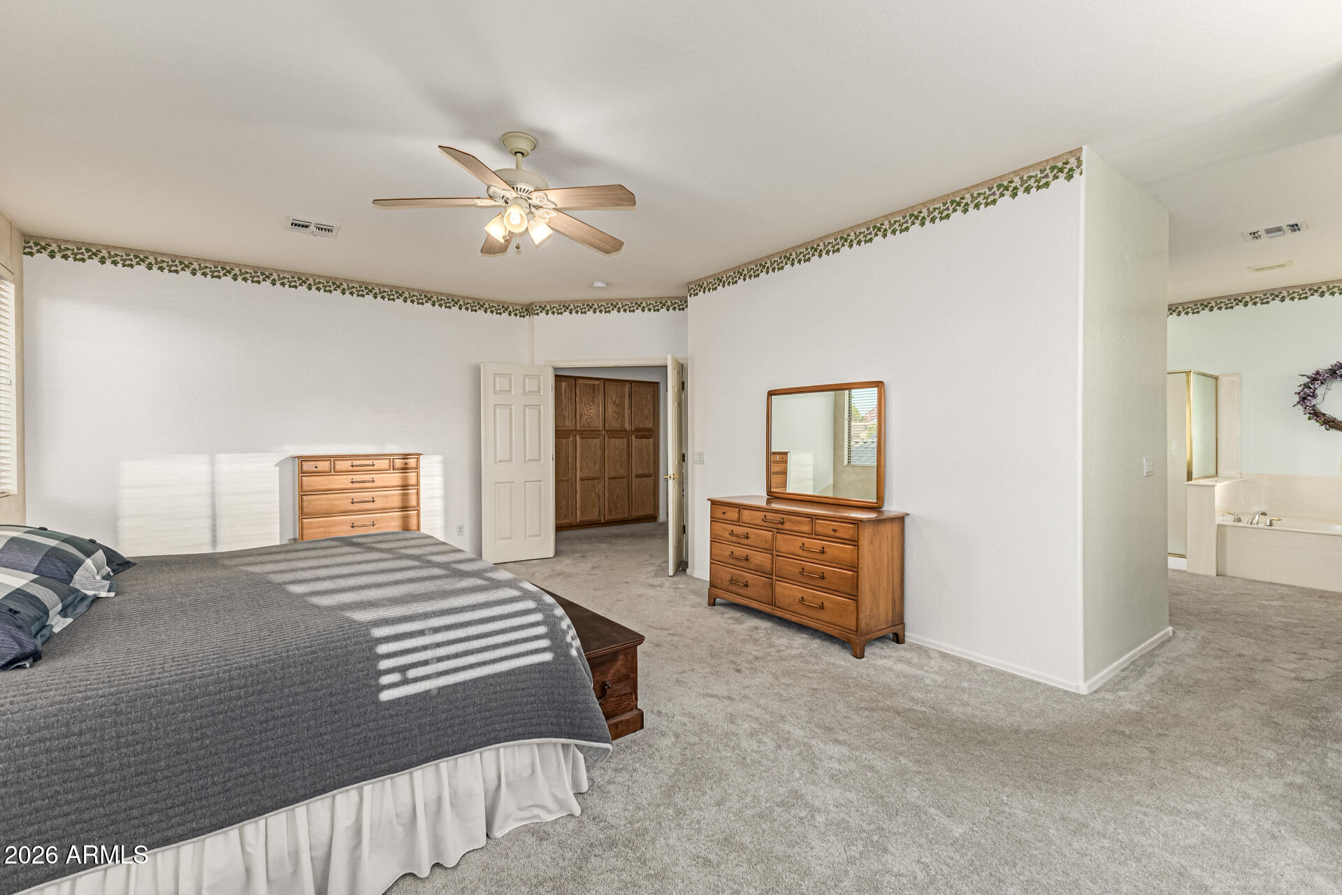 2326 South Porter Street Gilbert, AZ 85295 - Photo 20 of 29 a bedroom with a large bed and a chandelier