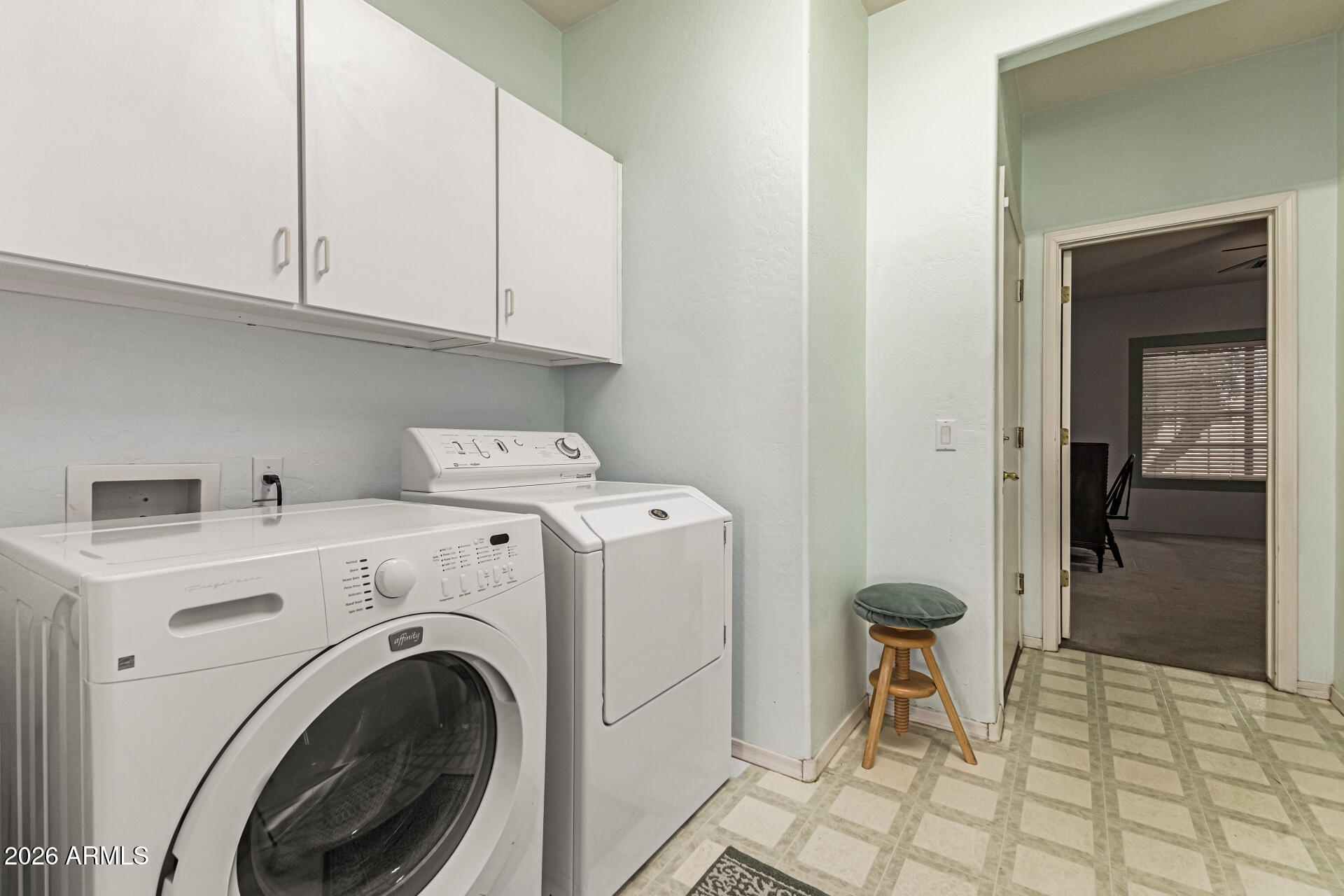 2326 South Porter Street Gilbert, AZ 85295 - Photo 28 of 29 a view of washer and dryer with bathroom in the background