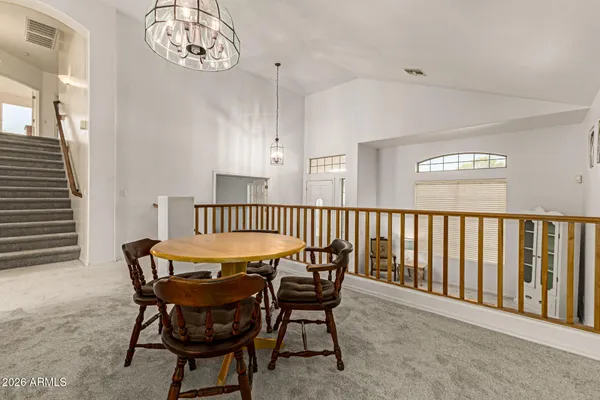 a dining room with furniture and a chandelier
