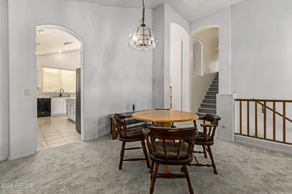 a view of a dining room with furniture and chandelier