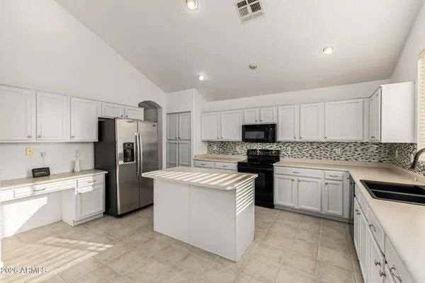a kitchen with stainless steel appliances granite countertop a refrigerator stove a sink and dishwasher