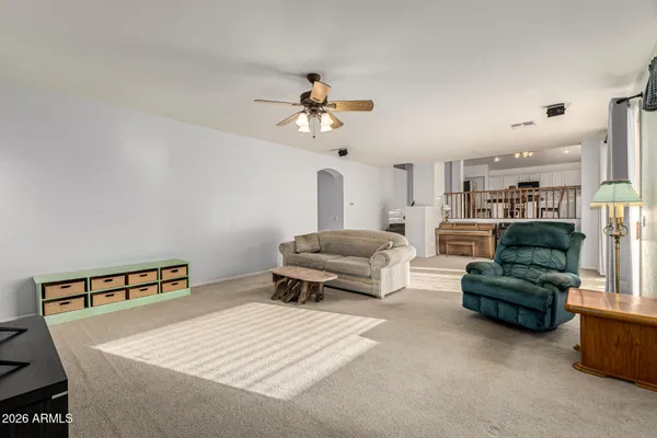 a living room with furniture and a chandelier