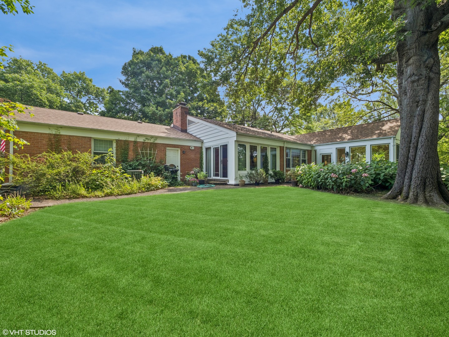 1881 West Tweed Road Inverness, IL 60067 - Photo 19 of 22 a front view of a house with a yard and potted plants