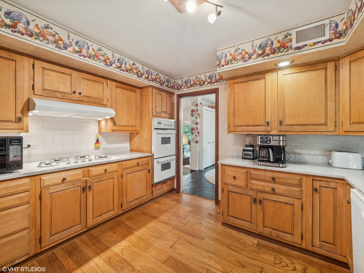 1881 West Tweed Road Inverness, IL 60067 - Photo 8 of 22 a kitchen with granite countertop a sink cabinets stainless steel appliances and a large window