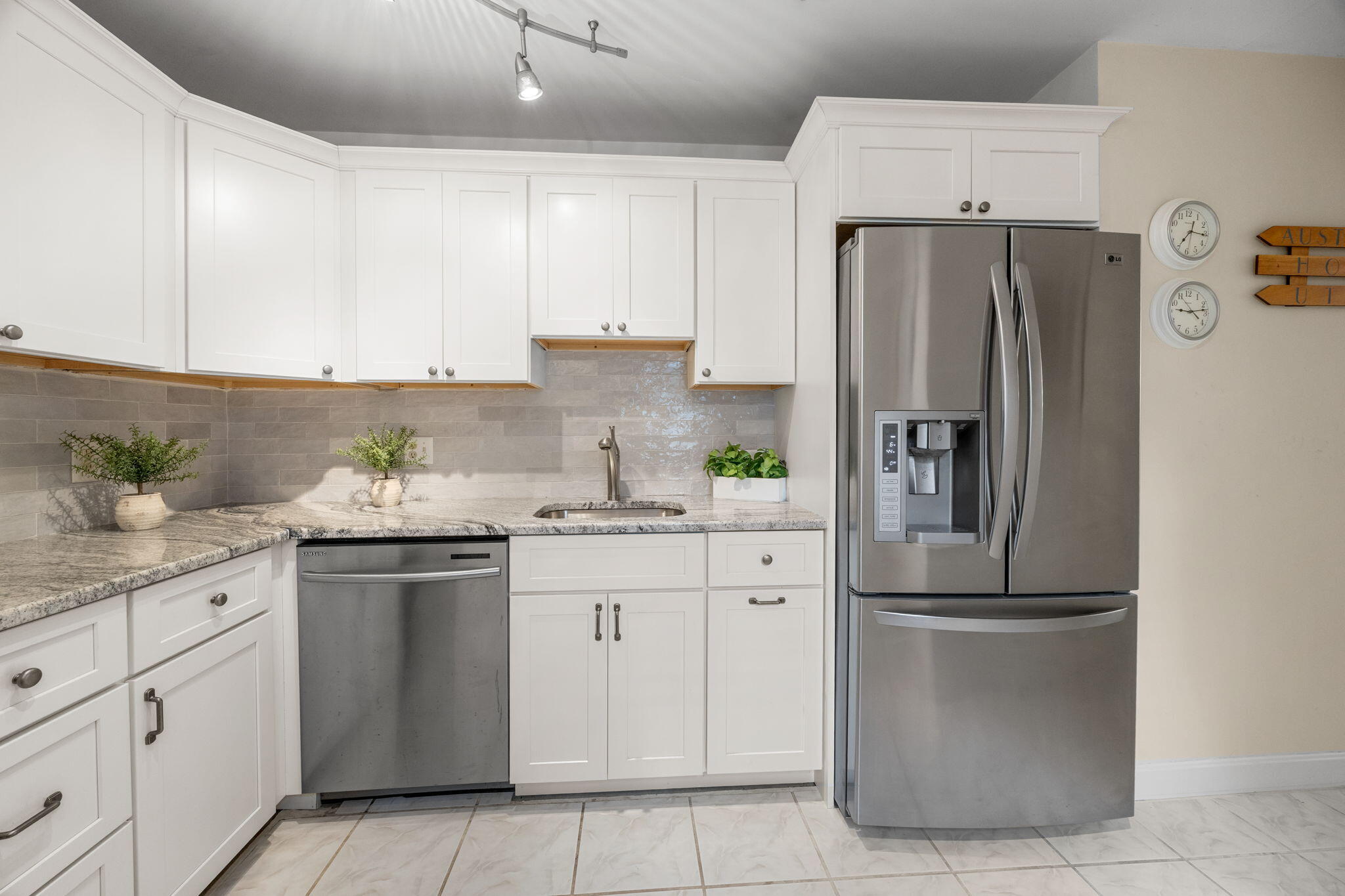 23 Landing Lane, Unit 23 Brewster, MA 02631 - Photo 12 of 33 a kitchen with kitchen island granite countertop cabinets and refrigerator