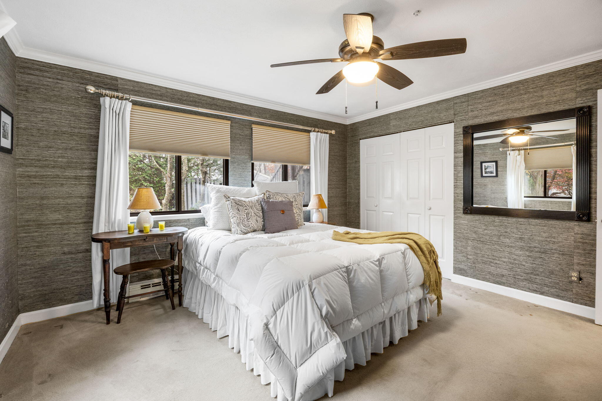 23 Landing Lane, Unit 23 Brewster, MA 02631 - Photo 15 of 33 a bedroom with a bed and a chandelier