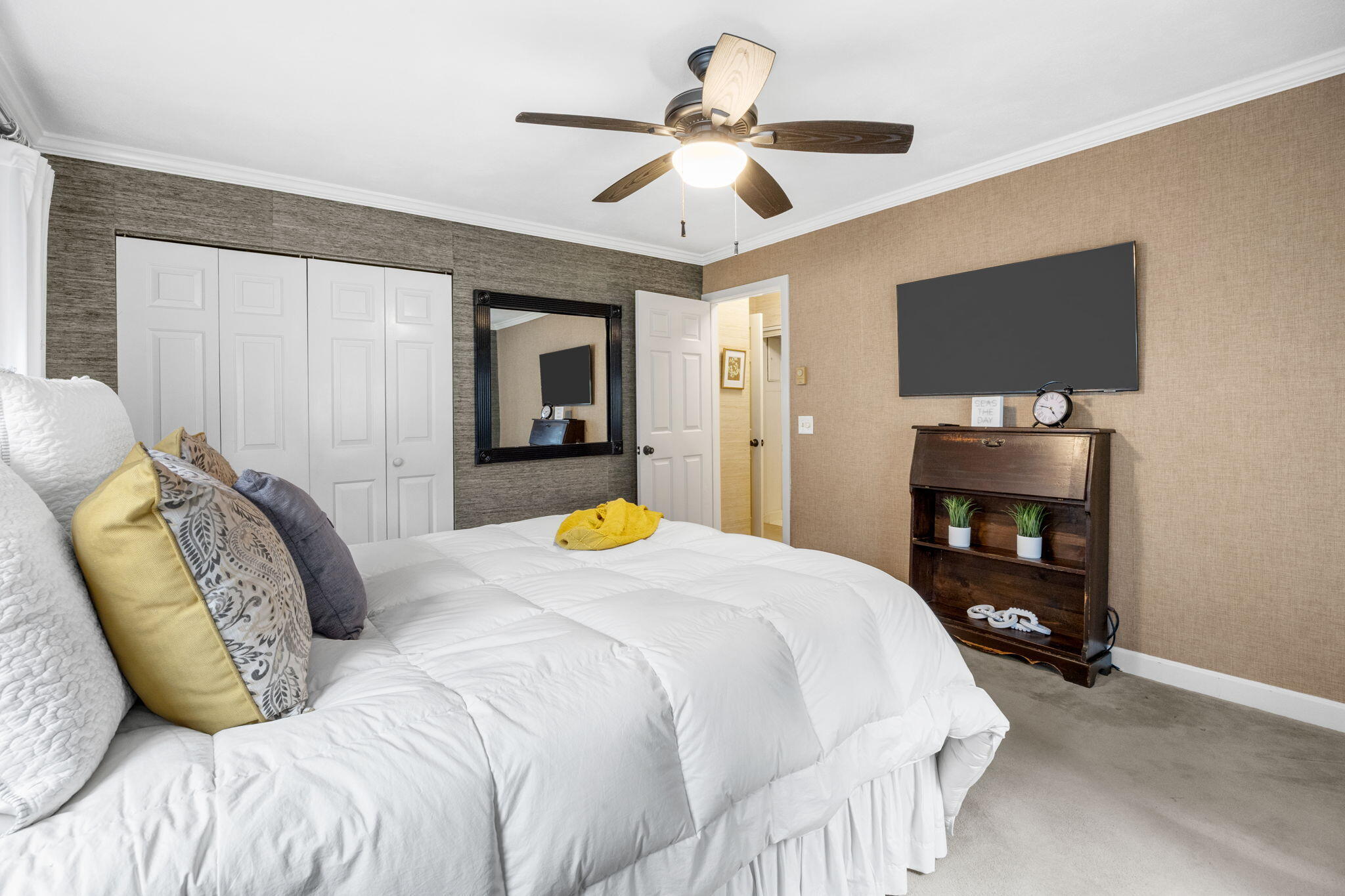 23 Landing Lane, Unit 23 Brewster, MA 02631 - Photo 16 of 33 a bedroom with a bed and a chandelier