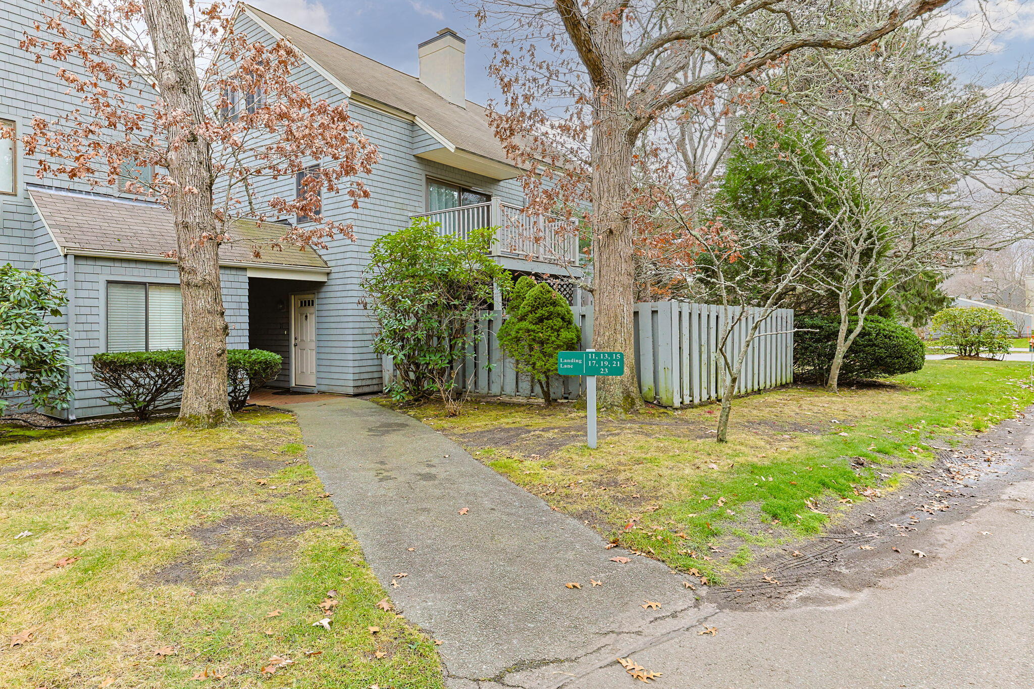 23 Landing Lane, Unit 23 Brewster, MA 02631 - Photo 2 of 33 a backyard of a house with plants and trees
