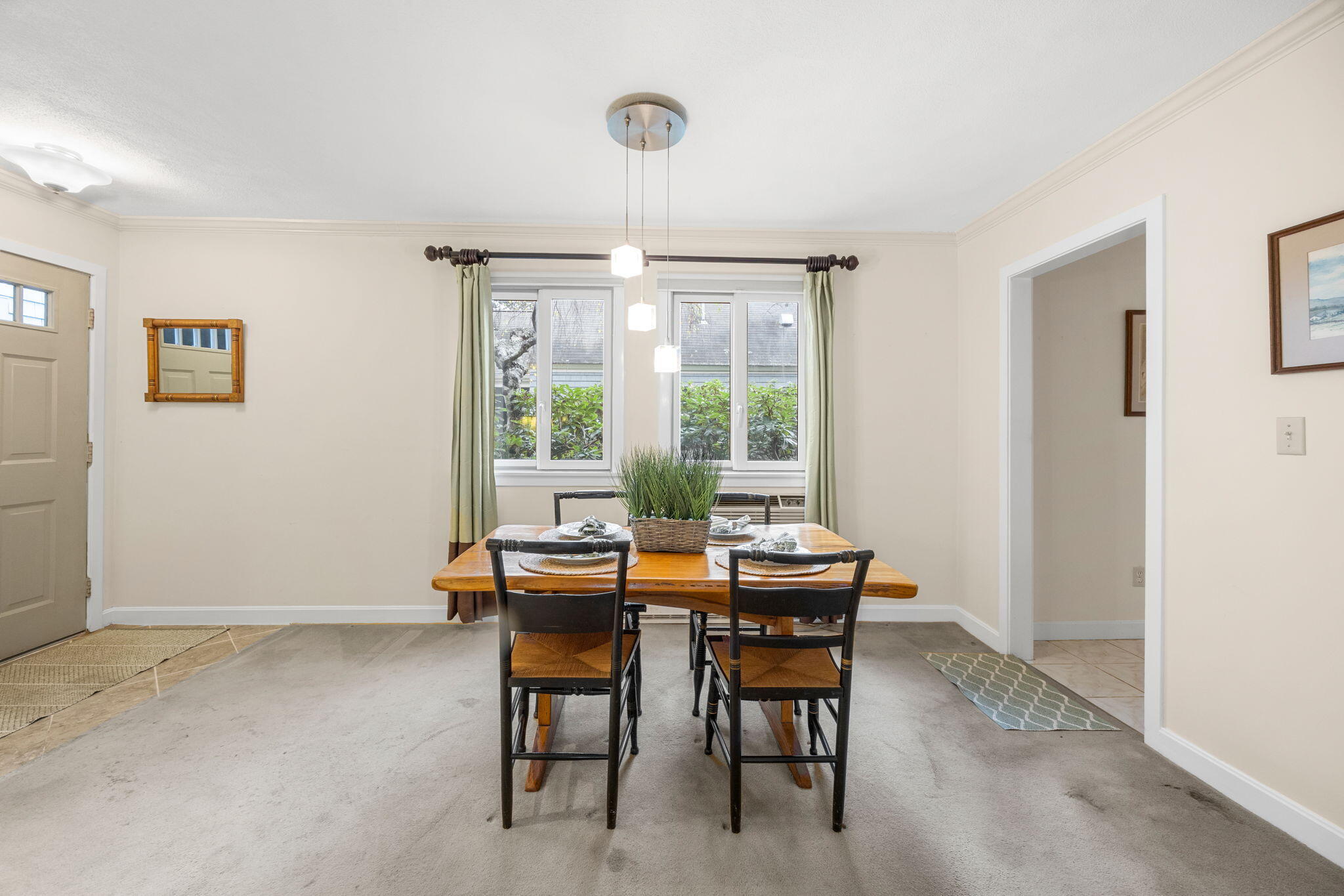 23 Landing Lane, Unit 23 Brewster, MA 02631 - Photo 5 of 33 a dining room with furniture a chandelier and wooden floor