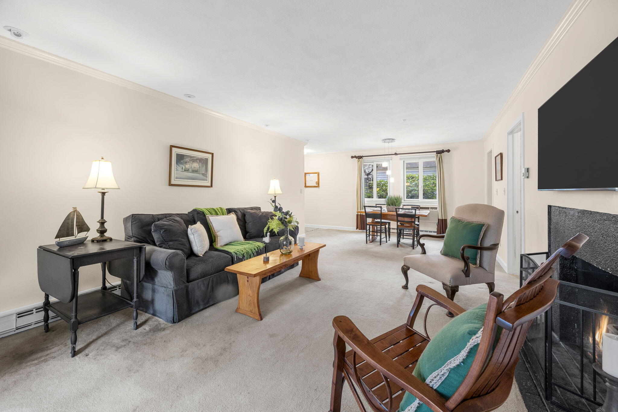 23 Landing Lane, Unit 23 Brewster, MA 02631 - Photo 9 of 33 a living room with furniture a flat screen tv and a fireplace