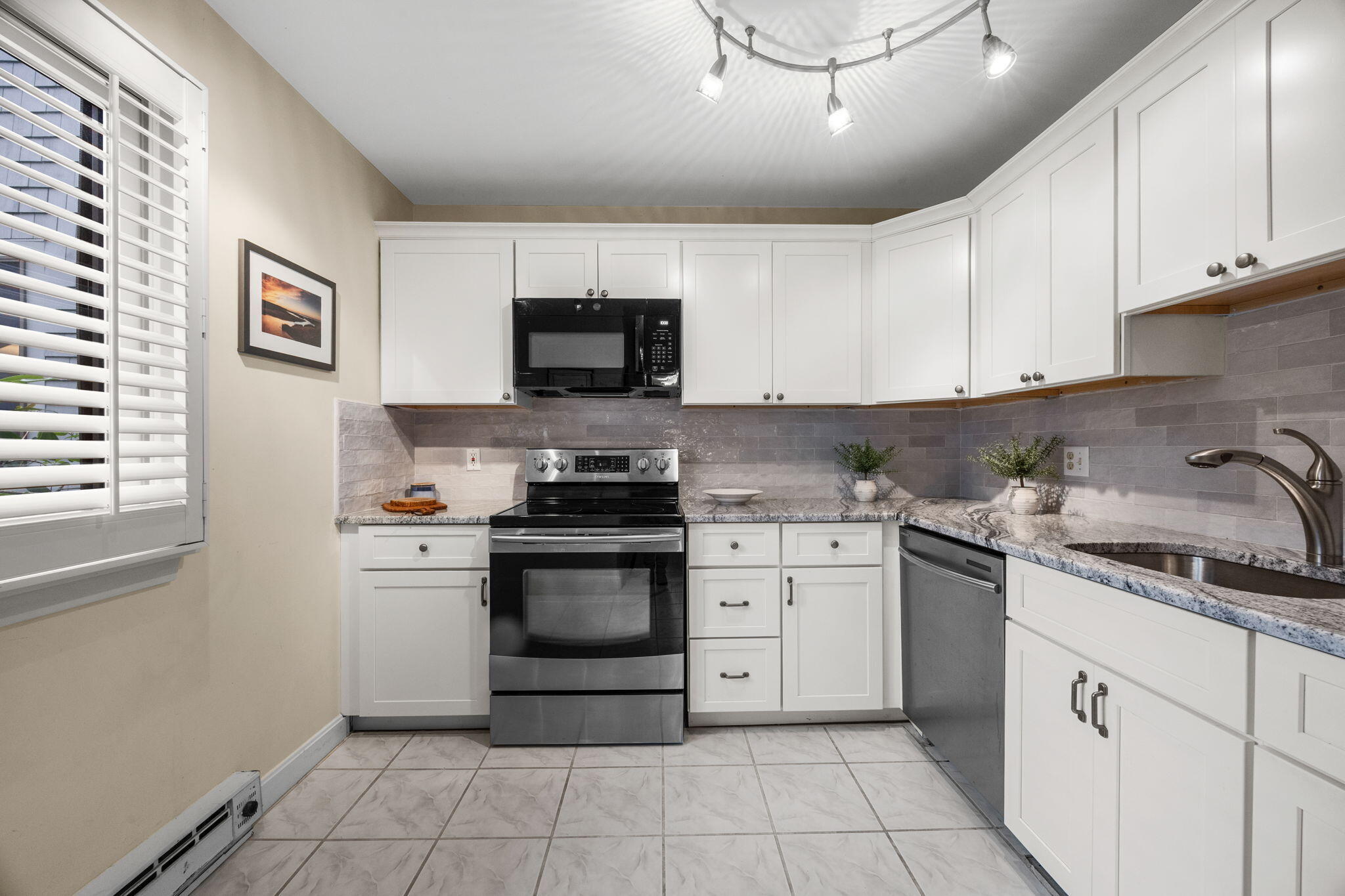 23 Landing Lane, Unit 23 Brewster, MA 02631 - Photo 10 of 33 a kitchen with stainless steel appliances a stove sink microwave and cabinets