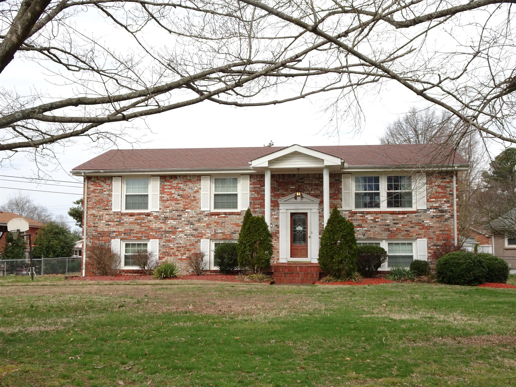 2143 Post Road Clarksville, TN 37043 - Photo 1 of 19 a front view of a house with a garden and yard