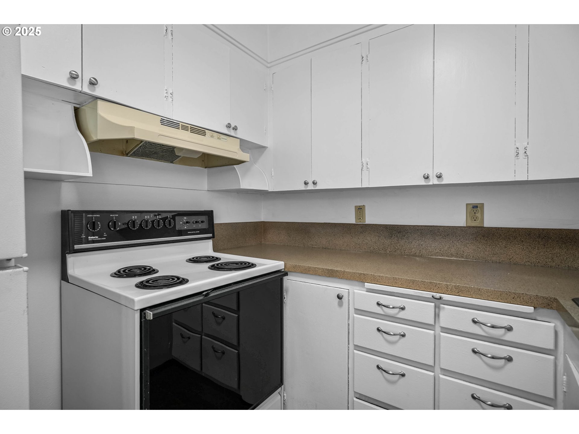 1908 Northeast 72nd Avenue Portland, OR 97213 - Photo 21 of 45 a kitchen with white cabinets and black appliances