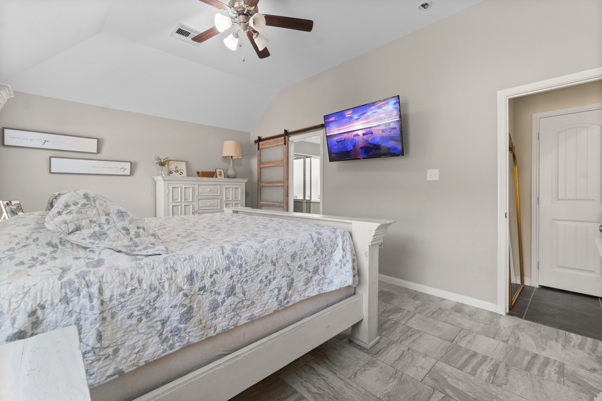 28987 Birch Green Way Spring, TX 77386 - Photo 17 of 32 a bedroom with a bed and a chandelier