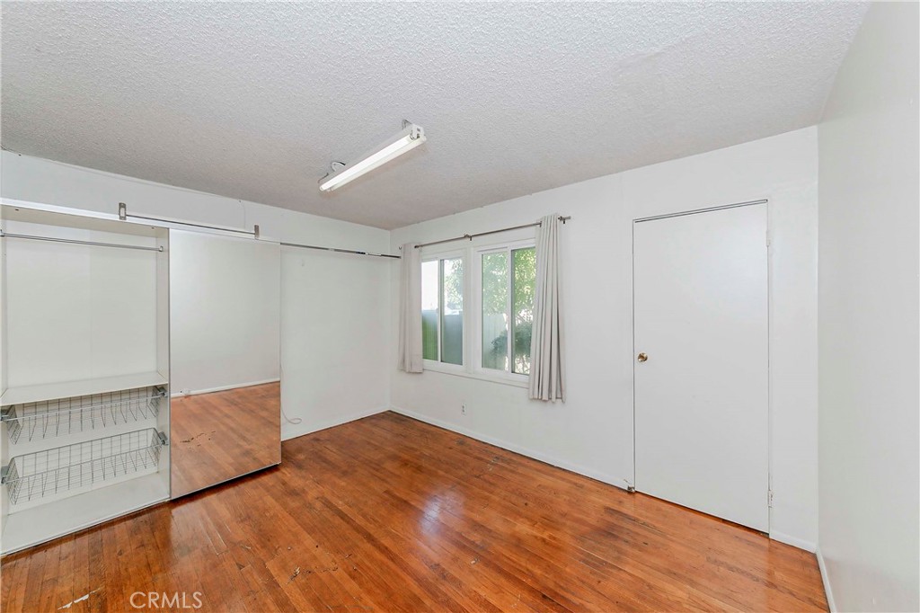 9002 Imperial Avenue Garden Grove, CA 92844 - Photo 18 of 20 a view of empty room with wooden floor and fan