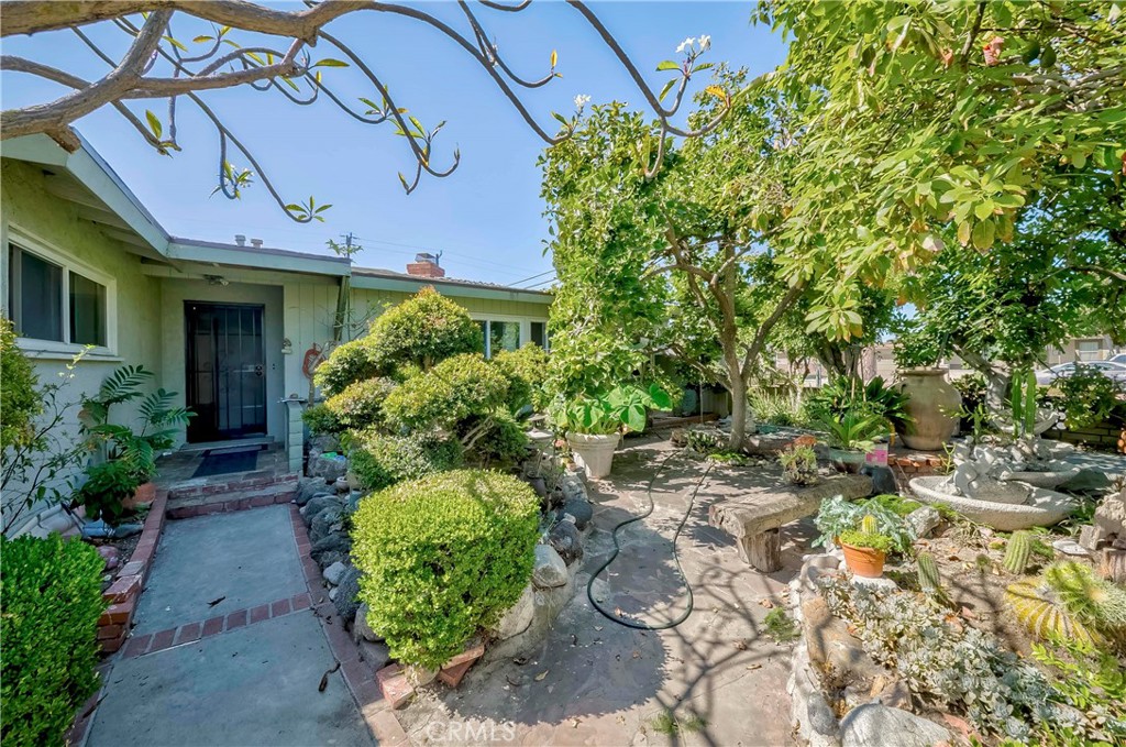 9002 Imperial Avenue Garden Grove, CA 92844 - Photo 3 of 20 a front view of a house with a yard garage and outdoor seating