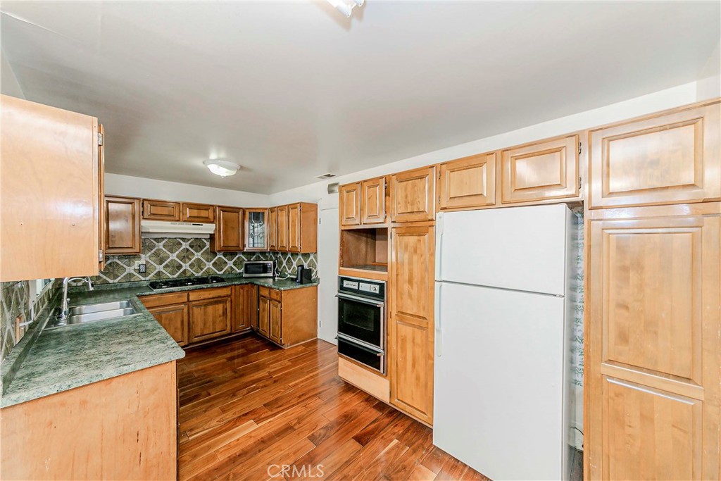 9002 Imperial Avenue Garden Grove, CA 92844 - Photo 7 of 20 a kitchen with stainless steel appliances granite countertop a refrigerator a stove a sink and a microwave