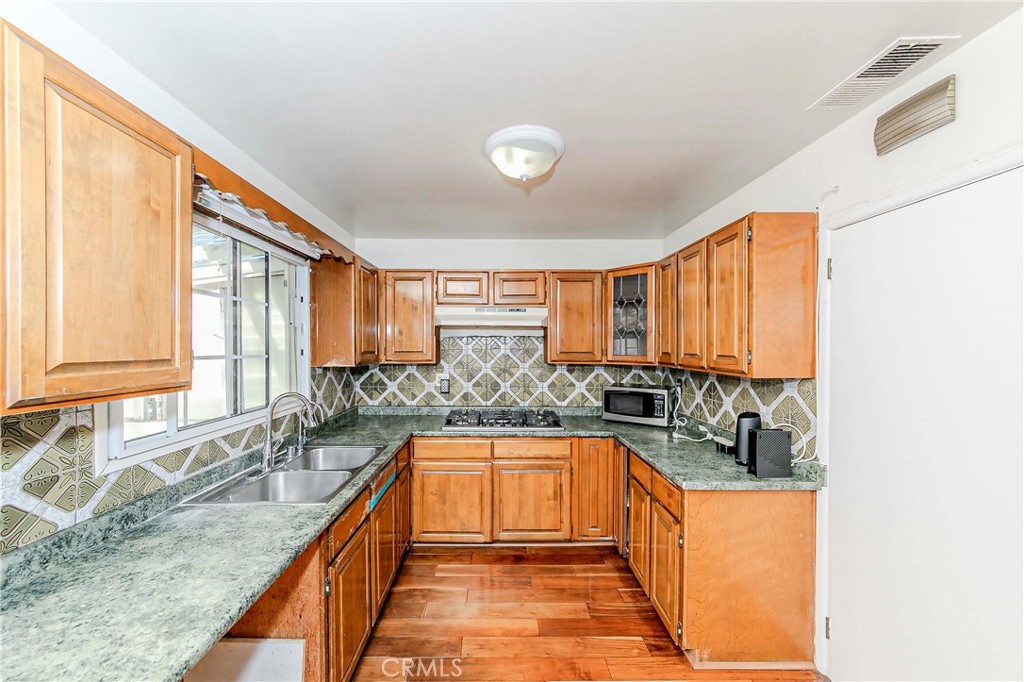 9002 Imperial Avenue Garden Grove, CA 92844 - Photo 8 of 20 a large kitchen with granite countertop a sink and a large window