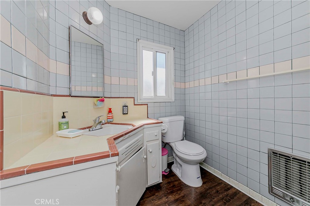 9002 Imperial Avenue Garden Grove, CA 92844 - Photo 9 of 20 a bathroom with a sink a toilet and a mirror