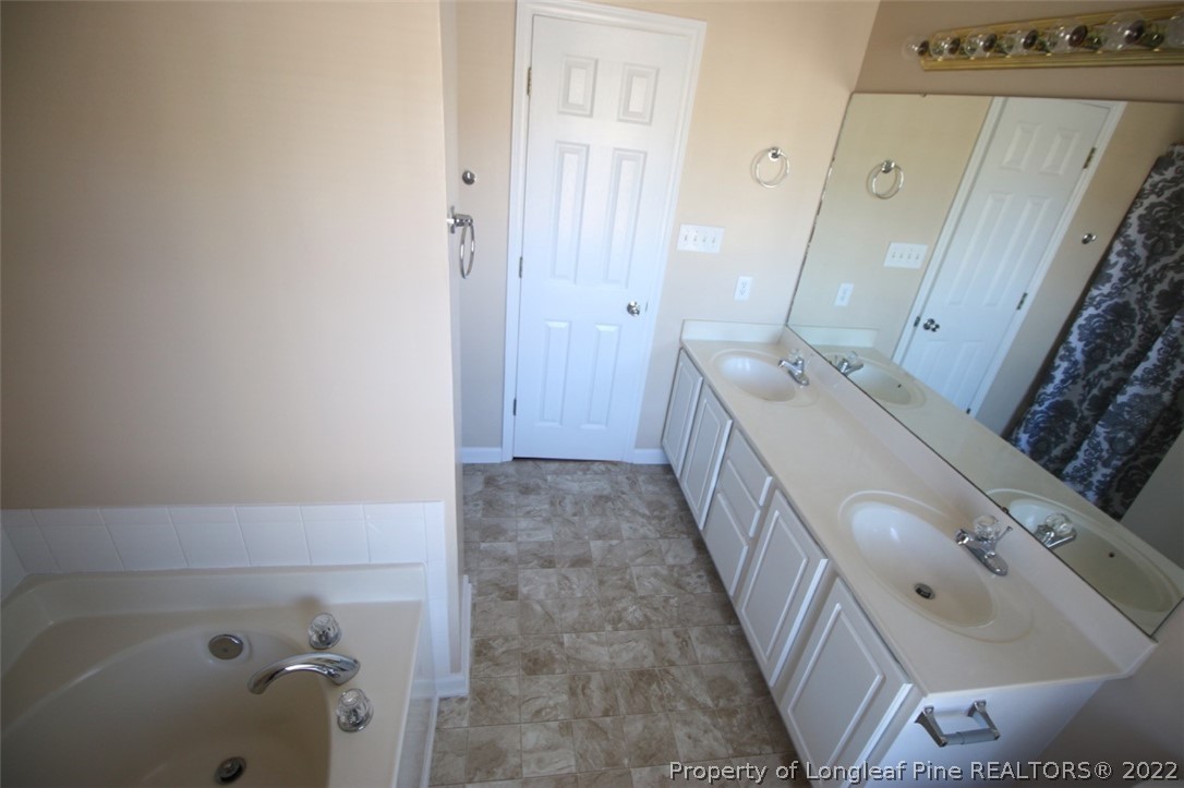 2004 Ivey Commons Road Fayetteville, NC 28306 - Photo 14 of 21 a bathroom with a tub sink and mirror