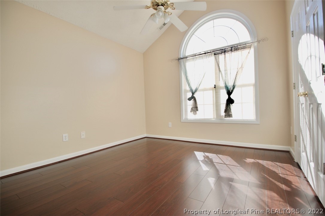 2004 Ivey Commons Road Fayetteville, NC 28306 - Photo 17 of 21 an empty room with wooden floor fan and windows