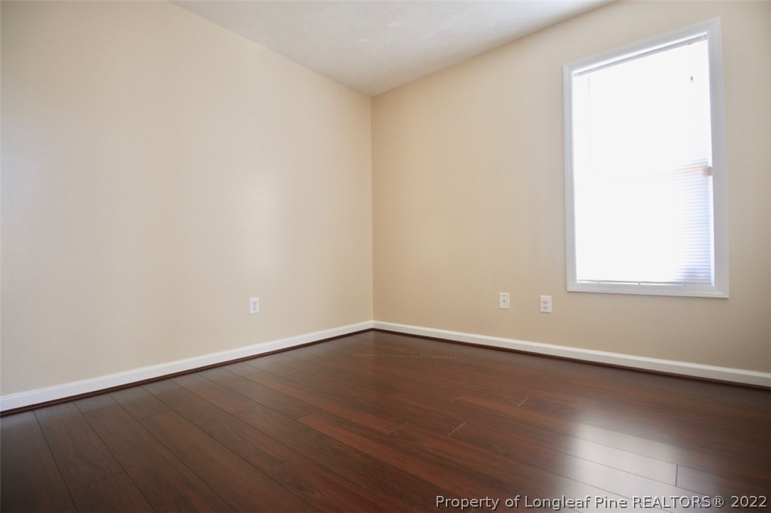2004 Ivey Commons Road Fayetteville, NC 28306 - Photo 18 of 21 an empty room with wooden floor and windows