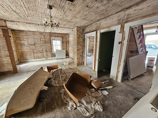 a view of a room with wooden floor and chair