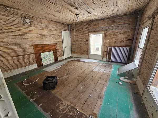 a view of an empty room with a fireplace