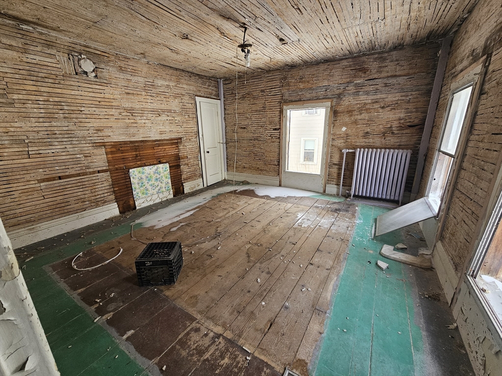 56 Liberty Street North Adams, MA 01247 - Photo 2 of 32 a view of an empty room with a fireplace