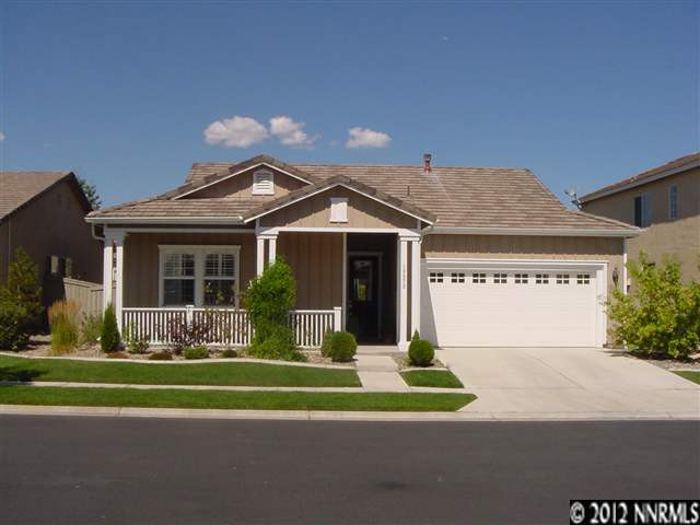 10573 Twin Bridges Way Reno, NV 89521 - Photo 1 of 1 a front view of a house with a yard table and chairs
