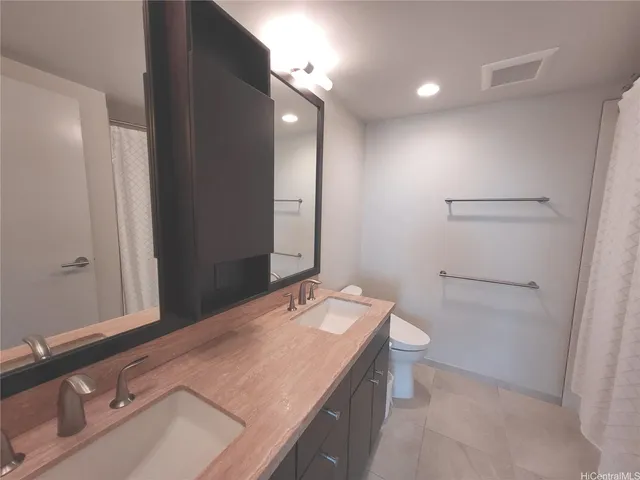 a bathroom with a sink a toilet and mirror