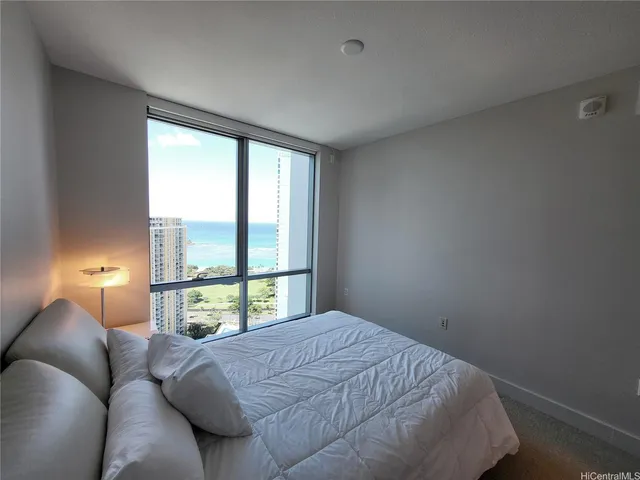 a bed sitting in a bedroom next to a window