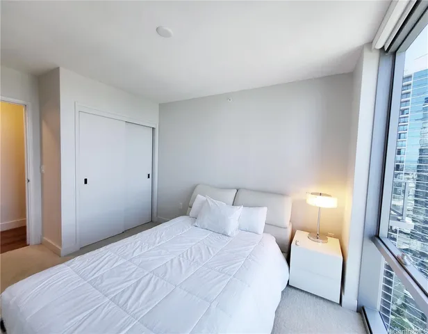 a bedroom with a bed and a window