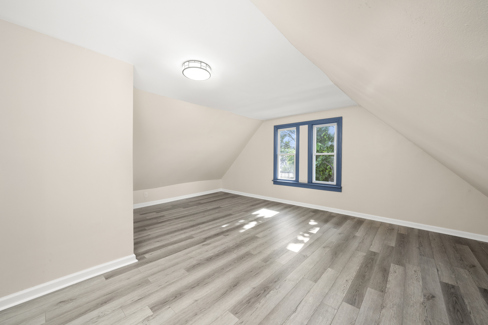 7128 South May Street Chicago, IL 60621 - Photo 19 of 32 an empty room with wooden floor and windows