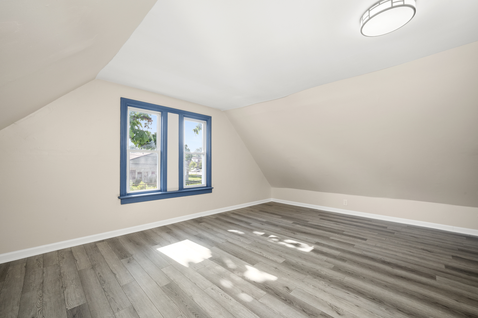 7128 South May Street Chicago, IL 60621 - Photo 22 of 32 a view of an empty room with wooden floor and a window