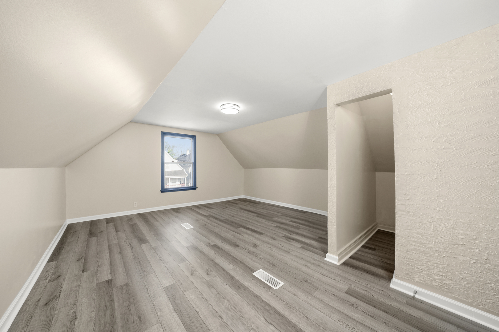 7128 South May Street Chicago, IL 60621 - Photo 24 of 32 an empty room with wooden floor and windows