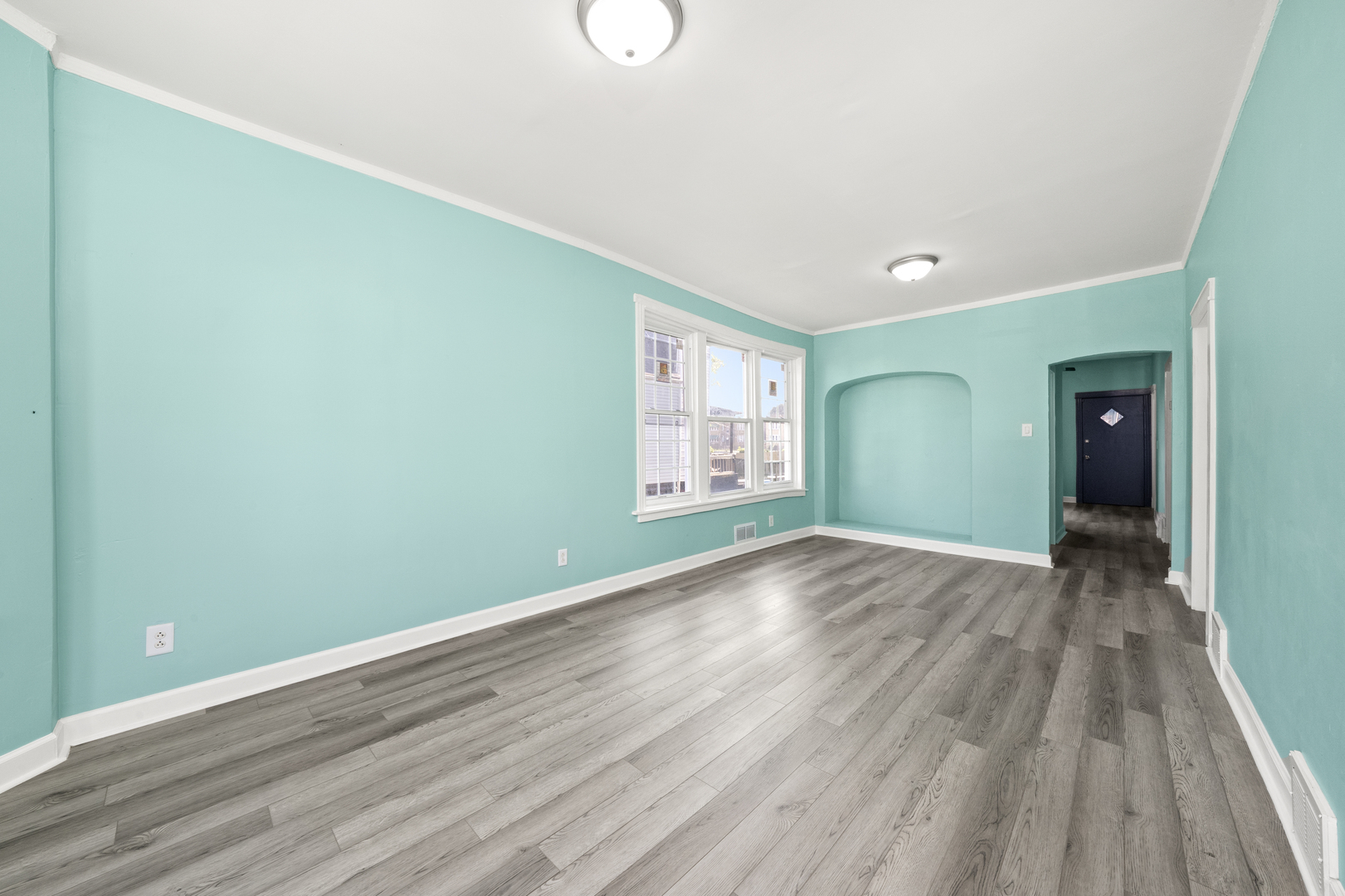 7128 South May Street Chicago, IL 60621 - Photo 4 of 32 a view of empty room with wooden floor and fan