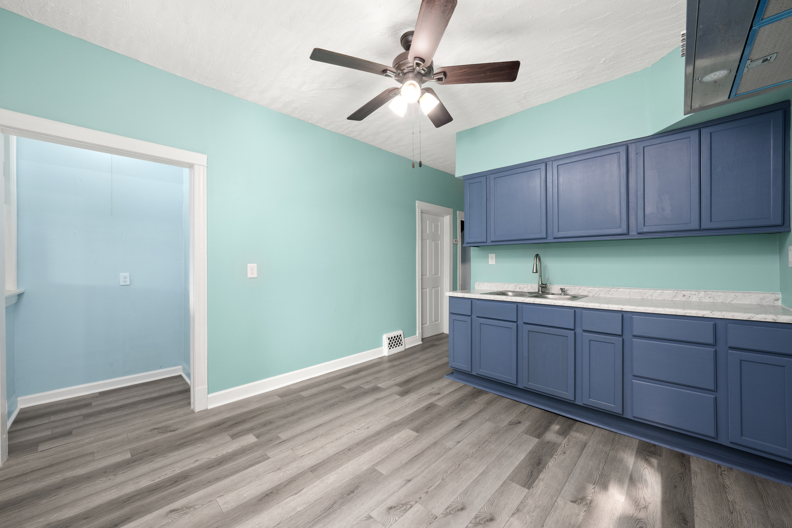 7128 South May Street Chicago, IL 60621 - Photo 8 of 32 a room with cabinets and ceiling fan