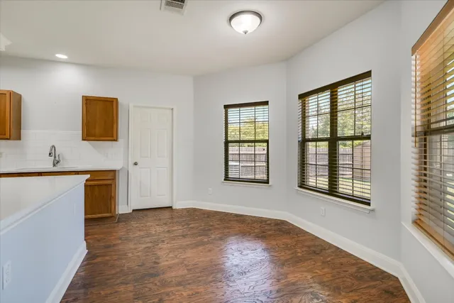 a view of a dining room with furniture and window